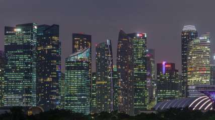 Fototapeta na wymiar Business Financial Downtown City and Skyscrapers Tower Building at Marina Bay day to night timelapse, Singapore