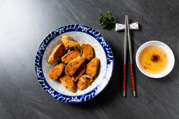 Hae Keung is fried shrimp rolled or shrimp ball. Chinese Traditional cuisine concept. Dumplings Dim Sum in bamboo steamer with text copy space. Asian food background