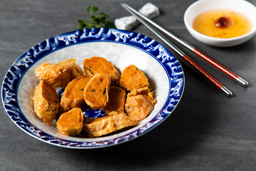 Hae Keung is fried shrimp rolled or shrimp ball. Chinese Traditional cuisine concept. Dumplings Dim Sum in bamboo steamer with text copy space. Asian food background