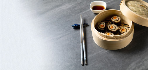 Seaweed algae with Pork Dim sum. Chinese Traditional cuisine concept. Dumplings Dim Sum in bamboo steamer with text copy space. Asian food background