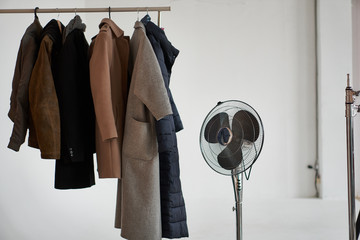Outerwear hangs on a hanger. Coats and jackets on the crossbar. © Vladimir