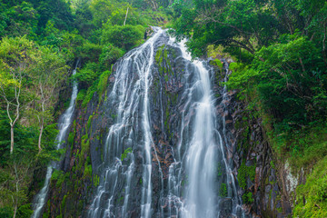 Fototapeta na wymiar Efrata waterfall in the rainforest highlands near Lake Toba in Sumatra, travel destination, Indonesia. Long exposure water flowing effect.