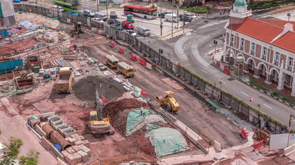 A large construction site in the city timelapse with heavy vehicle at work, excavator and bulldozer