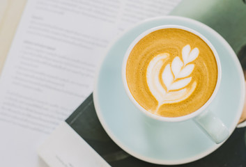 Cup of latte art coffee in coffee shop