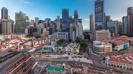 Naklejka premium Aerial view of Chinatown with red roofs and Central Business District skyscrapers timelapse, Singapore