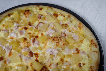 Italian pizza on gray plates on a white plate with spices and seasonings vegetables and meat.