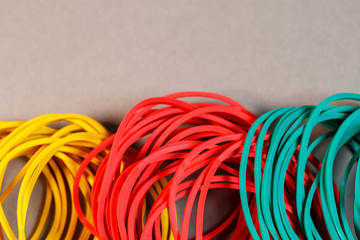 Colored rubber bands for money on a colored background. Stationery accessories