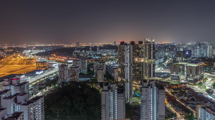 Fototapeta premium City skyline with commercial port of Singapore aerial night timelapse.