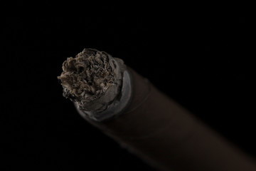 Cigar tip on black background . Macro shot