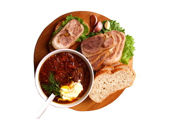 Meat roll sliced into pieces and a plate of borsch