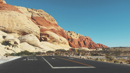 A paved road leads to a scenic red rock formation, located inside Red Rock Canyon National Conservation Area, in Las Vegas, Nevada.