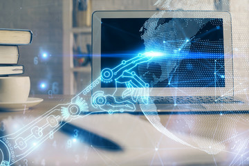 Computer on desktop in office with technology theme hologram. Multi exposure. Tech concept.