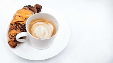 Cup of coffee and croissant on a white background