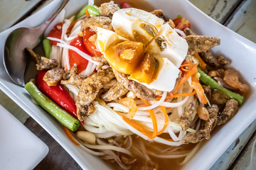 Thai Style Papaya Salad with Satled Eggs on plate.