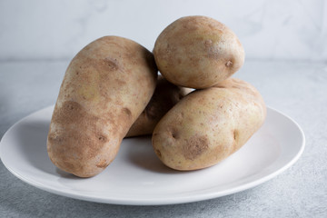 A closeup view of a plate of russet potatoes.