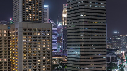 Night panorama with Marina Bay area and skyscrapers city skyline aerial timelapse.