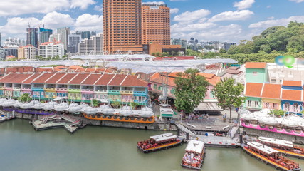 Tourist boats docking at Clarke Quay habour aerial timelapse.