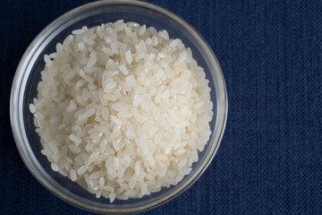 A top down view of a glass bowl of short grain rice.