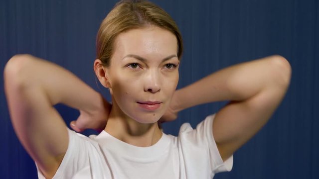 self-massage of neck and chin, woman demonstrates, preventions of osteochondrosis