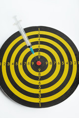 Medical syringe in a dart board