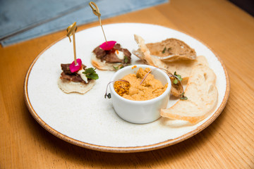 Fresh pate served with slices of bread.