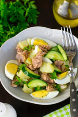 Healthy potato salad with cucumber, boiled eggs and tuna