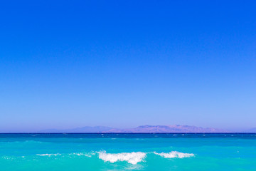 Obraz premium simply landscape with sea turquoise color , mountains on the horizon and gradient blue sky.Horizon line between calm mediterranean sea and clear blue sky