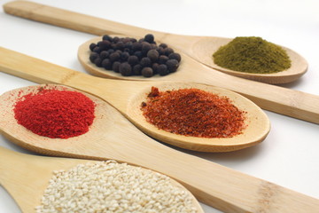 Five different spices on a white isolated background