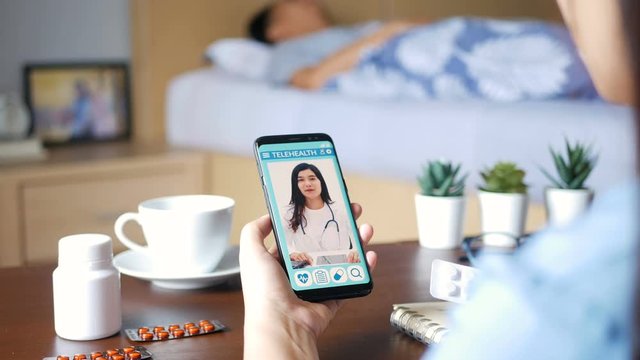 Patient's relatives use video conference, make online consultation with doctor on mobile application, ask doctor about illness , medication via video call. Telehealth, Telemedicine and online hospital