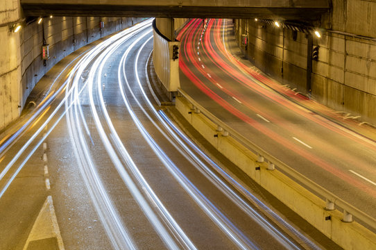 The lights of cars on the streets of a city at night