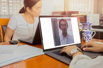 Businessman making video conference using laptop work from home prevent covid-19 concept.