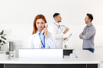 Female medical assistant working in clinic