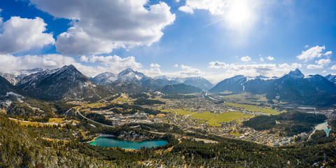 Panorama of circular deep valley basin of Reutte and Breitenwang with lake Urisee at sunny spring day - obrazy, fototapety, plakaty