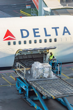 Loading of a cargo container on board of a Delta Airlines airplane on Schiphol Airport, The Netherlands on January 16, 2020