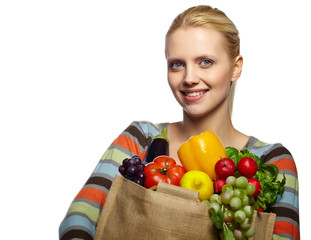 Woman holding grocery paper shopping bag full of fresh vegetables. Diet healthy eating concept isolated on a white background