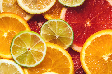 Fototapeta premium Flatlay pattern of citrus orange, lemon, lime and grapefruit slices background. Top view. Minimal design.