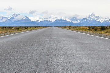 Street to Glacier National Park in El Chalten, Argentina, Patagonia with snow covered Fitz Roy Mountain in background