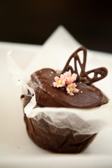 Chocolate brownie with pink frosting flowers