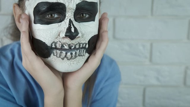 Girl with face art skull.