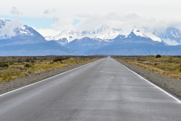 Fototapeta premium Street to Glacier National Park in El Chalten, Argentina, Patagonia with snow covered Fitz Roy Mountain in background
