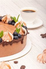 Chocolate poultry milk garnished with marshmallows and blueberries