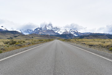 Street to Glacier National Park in El Chalten, Argentina, Patagonia with snow covered Fitz Roy Mountain in background