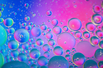 Oil drops in water. Defocused abstract psychedelic pattern pink and blue image. Abstract background with colorful gradient colors.
