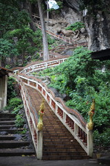 Naklejka premium staircase climbing in a cave, Wat Tham Khao Chakan, Sa Kaeo, Thailand.
