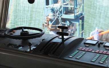 Control panel with steering wheel of a tug boat