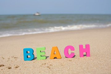 Colorful Letters ‘ BEACH’ on sandy beach, Let's enjoy holiday in summer season                              