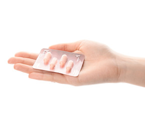 Female hand with pills on white background