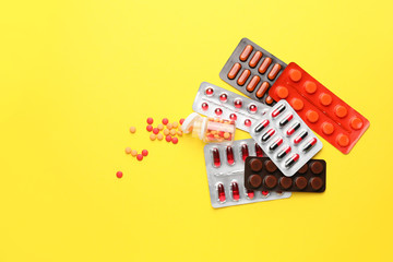 Different pills on color background