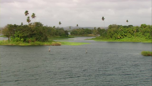 Aerial view of Lake Bayano, small islands with palms and cloud forest in Panama Central America, filmed with Cineflex stabilization camera system