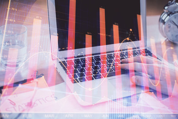 Naklejka premium Multi exposure of market chart with man working on computer on background. Concept of financial analysis.